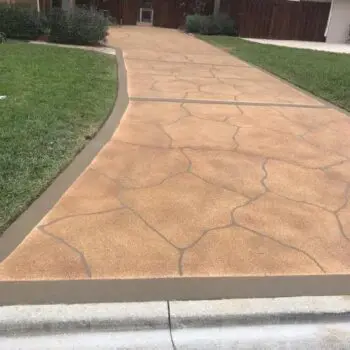 Stamped concrete driveway with landscaping