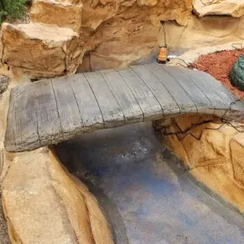 Wooden bridge over concrete path
