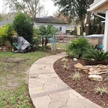 Concrete walkway beside landscaped garden