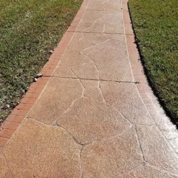 Stamped concrete walkway with grass