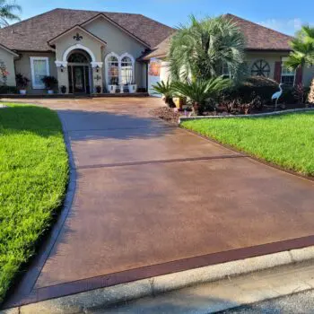 Concrete driveway with landscaped lawn