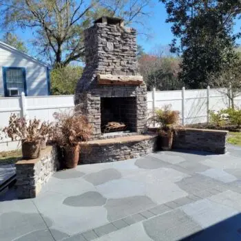 Outdoor stone fireplace patio installation