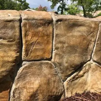 Stone-textured concrete wall installation