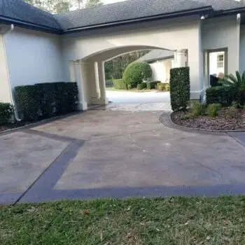 Stamped concrete driveway entrance house