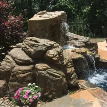 Rock waterfall feature by pool