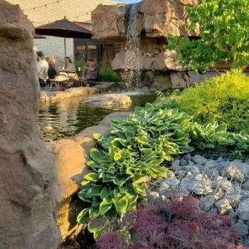 Garden waterfall beside outdoor seating