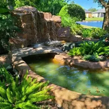 Tropical garden pond with waterfall