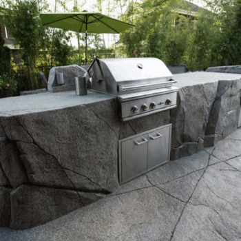 Outdoor concrete grill beside pool