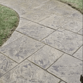 Stamped concrete driveway with grass