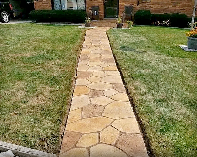Concrete stamped walkway with grass