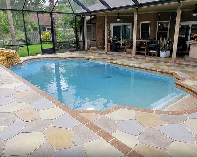 Backyard pool with stone patio