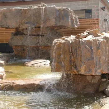 Natural stone waterfall backyard features