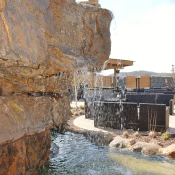 Pool waterfall with seating area